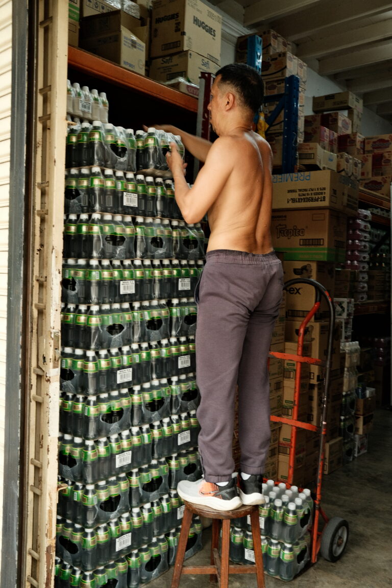 A elderly man stacking up crates. Georgetown, Malaysia
